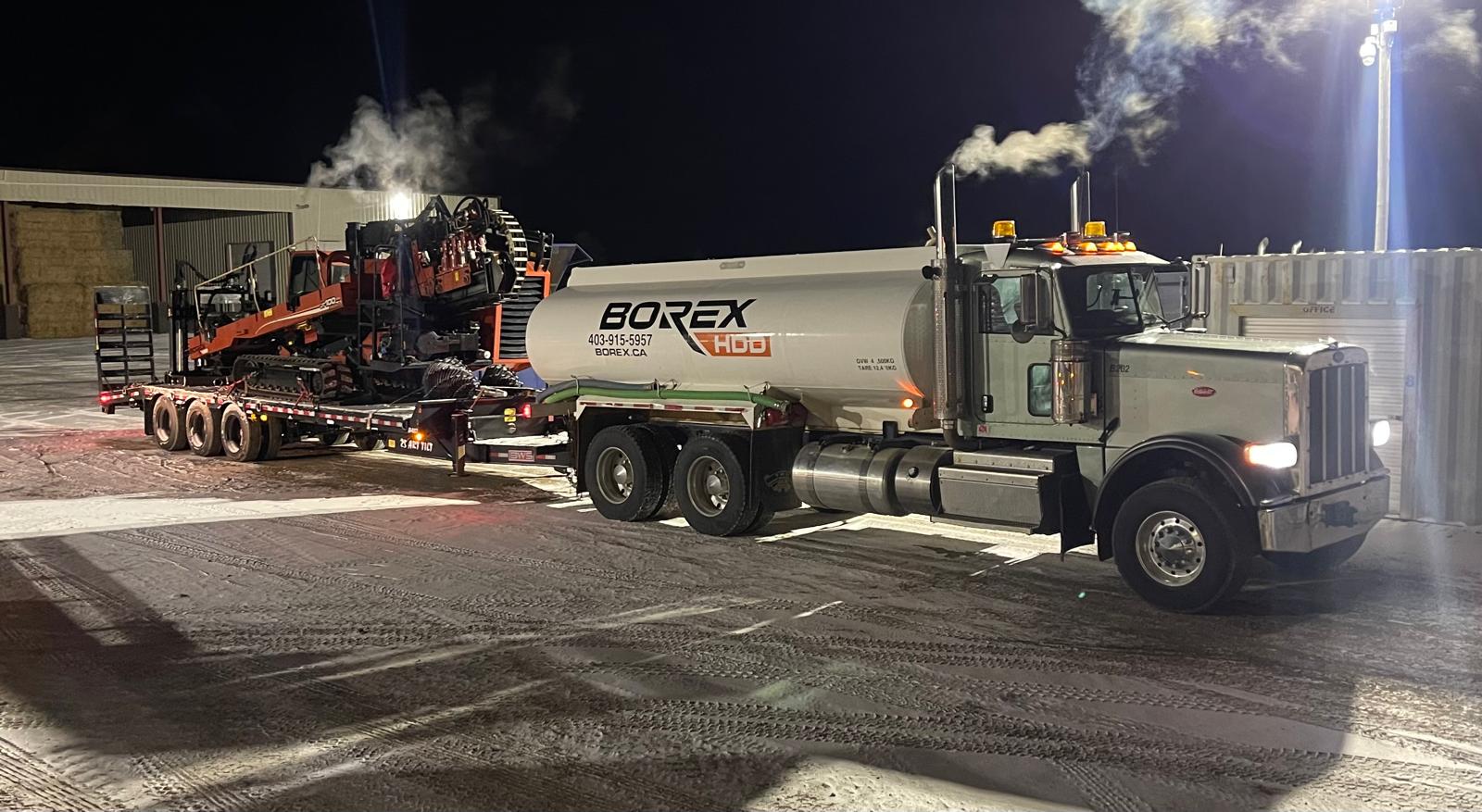 Horizontal directional drilling truck and support equipment on a job site